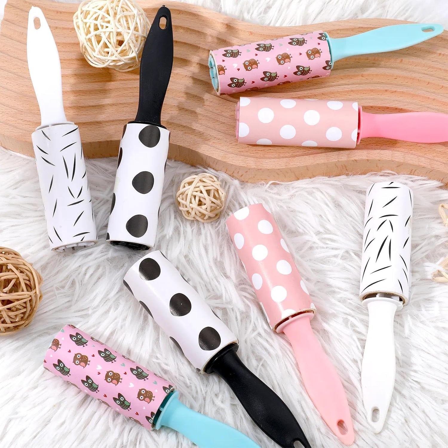 Set of colorful lint rollers on a wooden and textured surface